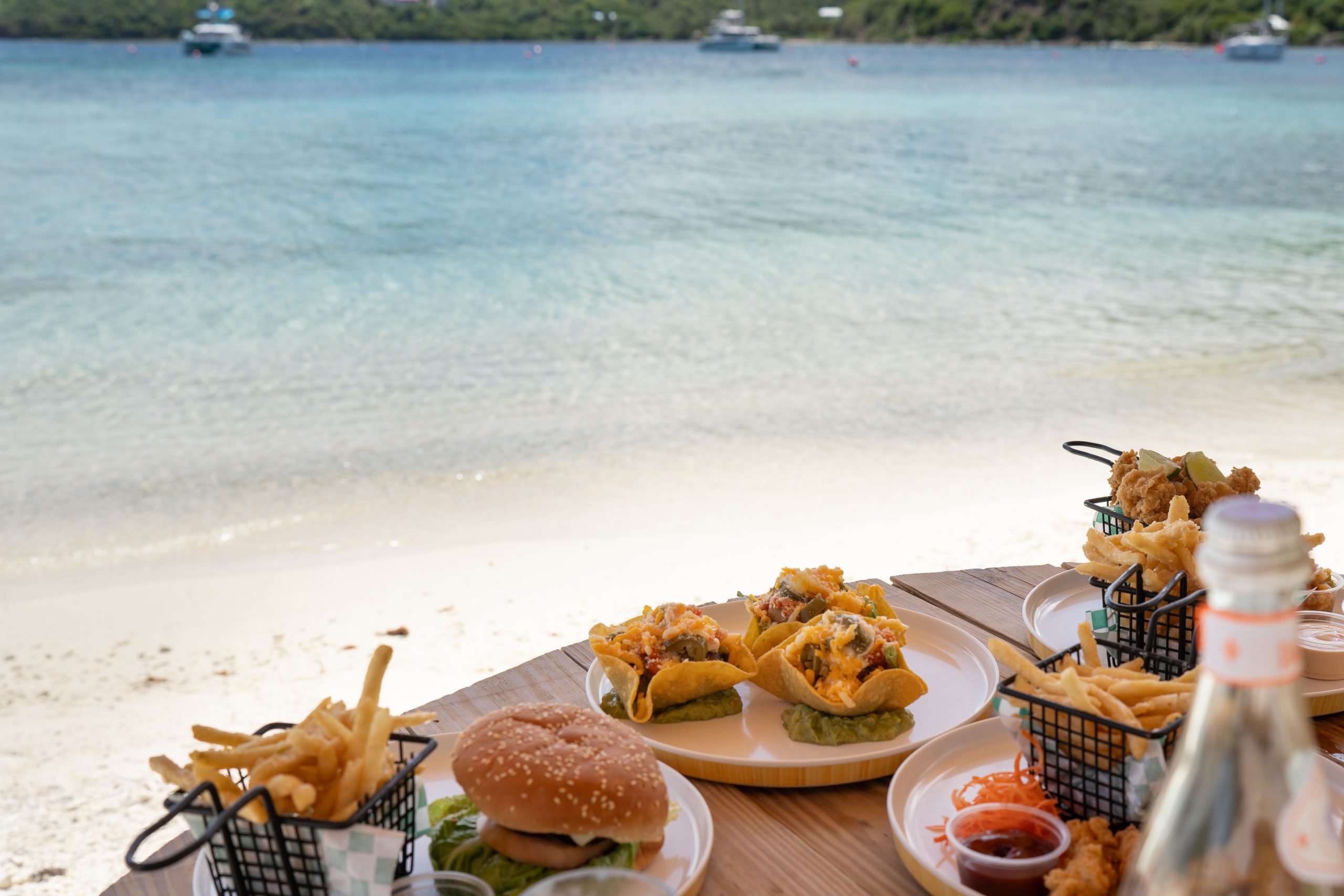 Marina Cay Waterside Dining table with plates of food beachside